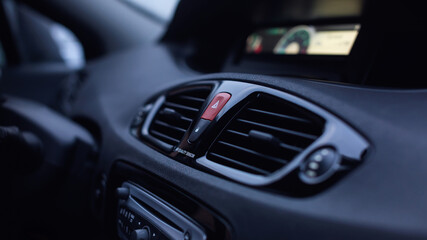Obraz na płótnie Canvas Ventilation vents with air flow deflectors and car emergency lights button.