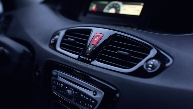 Ventilation vents with air flow deflectors and car emergency lights button.
