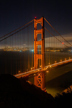 Night image of the iconic Golden Gate Bridge in portrait format