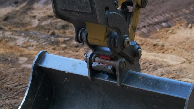 Pedestal Down Shot of a Tilt Excavator Bucket at a Construction Project