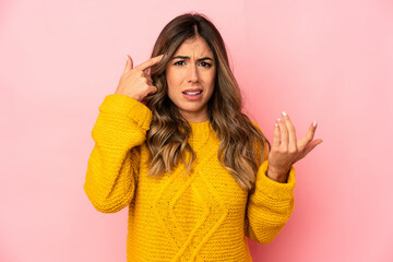 Young caucasian woman isolated showing a disappointment gesture with forefinger.