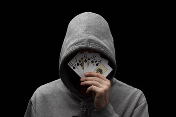 Man in hoodie with playing cards in his hand 