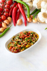 Healthy vegetarian food, traditional flavor Gavurdagi Salad with walnut. coban or choban salad. Mezze served alongside the main course. Appetizer