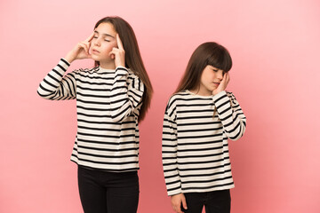 Little sisters girls isolated on pink background unhappy and frustrated with something