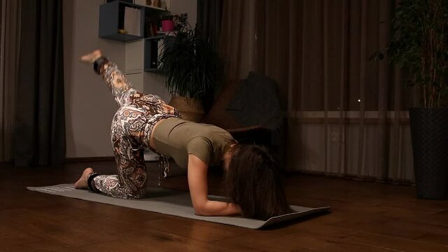 Young fit woman working out or doing fitness from home during lockdown. Stay active when gym are close