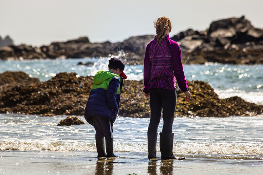 Children beach exploring at low tide while on vacation at Pacific Rim National Park near Tofino British Columbia.