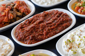 Traditional Turkish and Greek food appetizer table. Grilled eggplant salad (saksuka), Anamur salad, Baba Ghanoush (Mutabbal), pasha appetizer, spicy paste or harissa, purslane salad. Selective focus