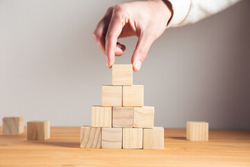 business man holding wooden cubes