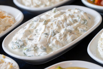 Traditional Turkish and Greek food appetizer table. Grilled eggplant salad (saksuka), Anamur salad, Baba Ghanoush (Mutabbal), pasha appetizer, spicy paste or harissa, purslane salad. Selective focus