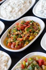 Traditional Turkish and Greek food appetizer table. Grilled eggplant salad (saksuka), Anamur salad, Baba Ghanoush (Mutabbal), pasha appetizer, spicy paste or harissa, purslane salad. Selective focus