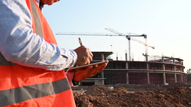 Engineers discuss about work of large building underconstruction
