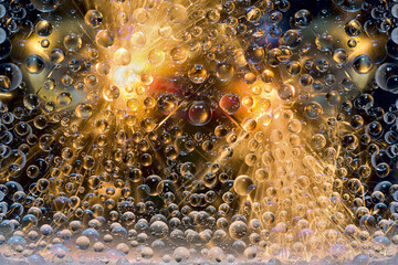 Flashes of light are reflected in transparent water droplets against a black background. Space abstraction. 3D render. 