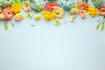 Spring floral composition made of fresh colorful flowers on light pastel background.