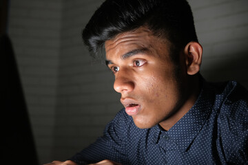 young man working on laptop stealing personal data 