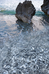 Amazing shingle beach with a boulder created by the erosion of the cliff over centuries.