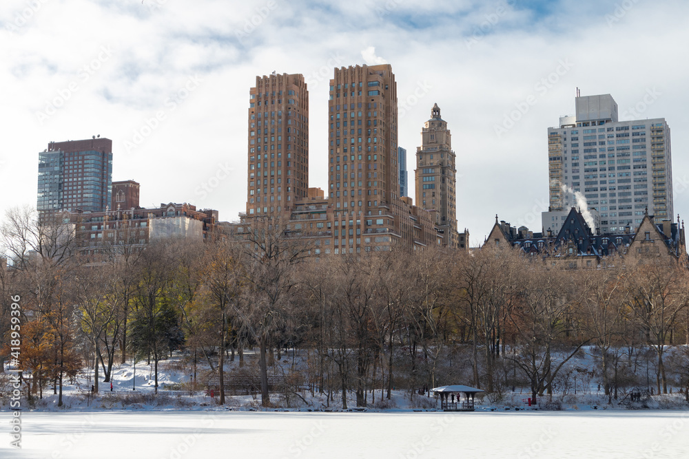 Wall mural The Upper West Side Skyline with the Frozen Lake with Snow at Central Park in New York City during Winter