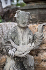Fototapeta na wymiar Beautiful asian statue with a farmer and his pig in the hands