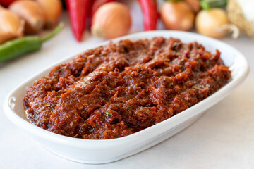 Spicy pastry appetizer (harissa) made with tomato, pepper, garlic, onion, pepper paste and olive oil. Acılı ezme. adjika