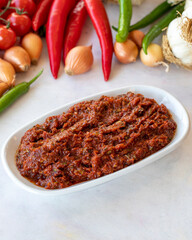 Spicy pastry appetizer (harissa) made with tomato, pepper, garlic, onion, pepper paste and olive oil. Acılı ezme. adjika