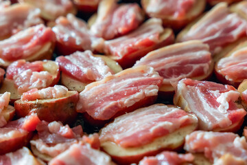 Raw potatoes with bacon, prepared for baking in the oven