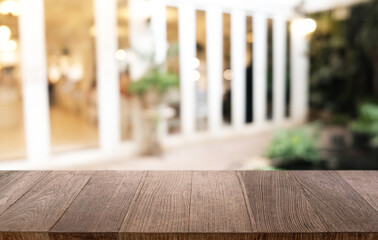 Empty dark wooden table in front of abstract blurred bokeh background of restaurant . can be used for display or montage your products.Mock up for space.