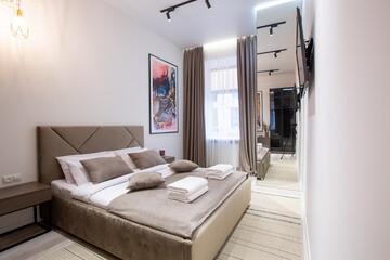 Fototapeta na wymiar Interior photography, modern bedroom, with large stylish bed, modern design, in beige