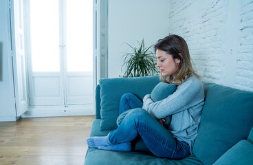 Young sad woman suffering from depression feeling desperate and lonely at home
