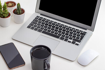 White desk office with laptop, smartphone and other work supplies with cup of coffee. Designer workspace on desk table essential elements on flat lay