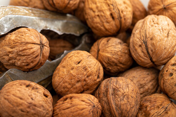Close-up walnuts pile. Walnut cracker