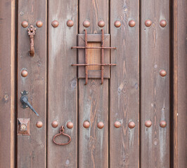 Old brown wood entrance door over blue painted wall