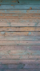 Texture of old wooden planks arranged horizontally with faded blue paint. Without people. Old village house made of wooden planks, with peeling paint. As a background or desktop wallpaper. 