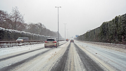 Driving on the highway A1 during a snowstorm in winter in the Netherlands