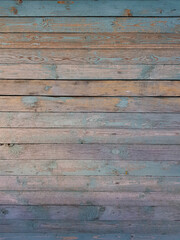 Texture of old wooden planks arranged horizontally with faded blue paint. Without people. Old village house made of wooden planks, with peeling paint. As a background or desktop wallpaper. 