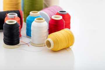 Different colored yarn on white background