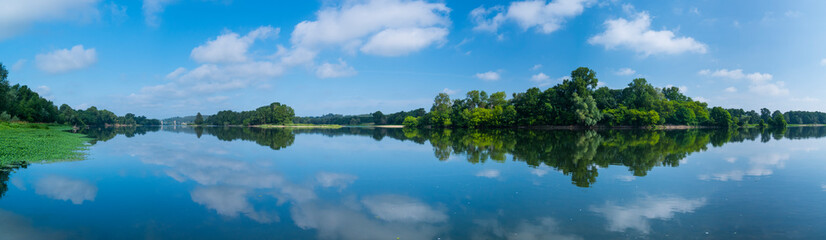 Fototapeta na wymiar Clouds reflected at Loire River, La Chapelle-aux-Naux, Indre-et-Loire Department, The Loire Valley, France, Europe