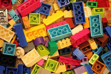 A lot colorful construction blocks from the children's model kit, close up top view texture for background