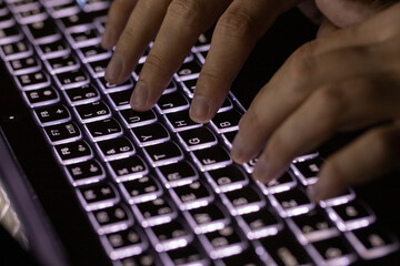 Close-up image of male hands working on laptop searching or typing message for new project. Selective Focus