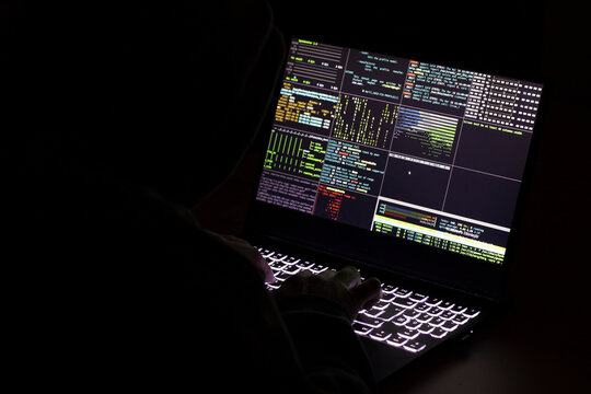 A computer programmer and hacker prints a code on a laptop keyboard to break into a mysterious organizational system.