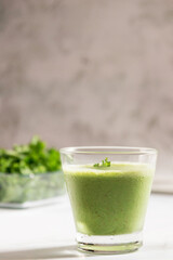 Healthy green kale smoothie with greek yogurt, almond and honey in glass isolated on white table background. Kale is considered a superfood because it's a great source of vitamins and minerals.