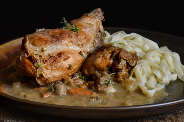 Rabbit stewed with vegetables and wine.