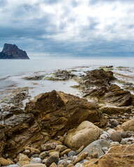 Sea waves lash line impact rock on the beach, located in Alicante, Spain, View