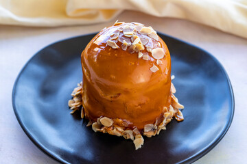 Raspberry and banana cake in a black presentation plate
