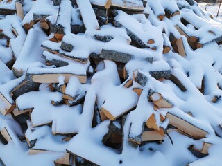wood in the snow a large pile is piled under the snow