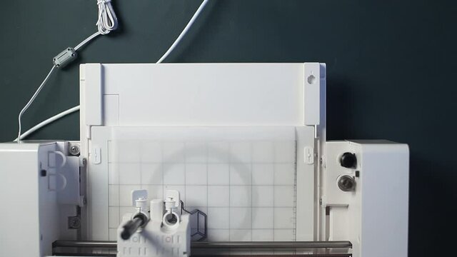 Digital cutting and creasing plotter during work top view 4K