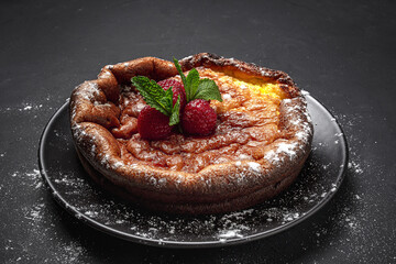 Homemade cheesecake with blueberries, currants, strawberries and mint leaves from above. Flat lay