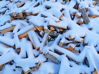 wood in the snow a large pile is piled under the snow