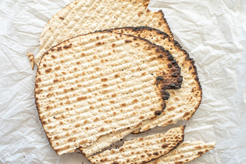 Matzah bread for Jewish holiday Pesach on white background.