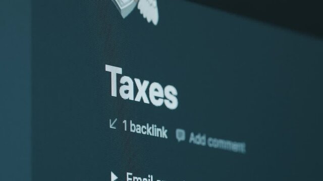 Extreme close up shot focusing on the word Taxes written on a computer screen