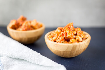 Steamed white beans with meat in tomato sauce. Homemade food concept. Close up. Selective focus.