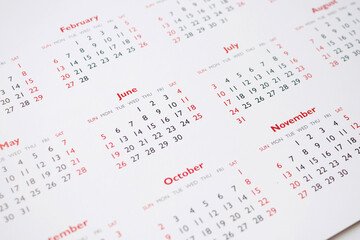 Close up calendar page dates and month background business planning appointment meeting concept